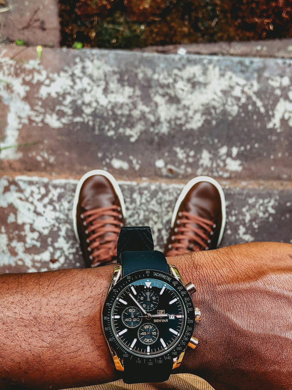 black leather strap black round chronograph watch
