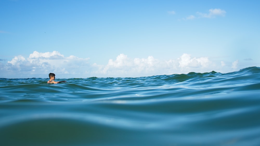 blue body of water under blue sky during daytime