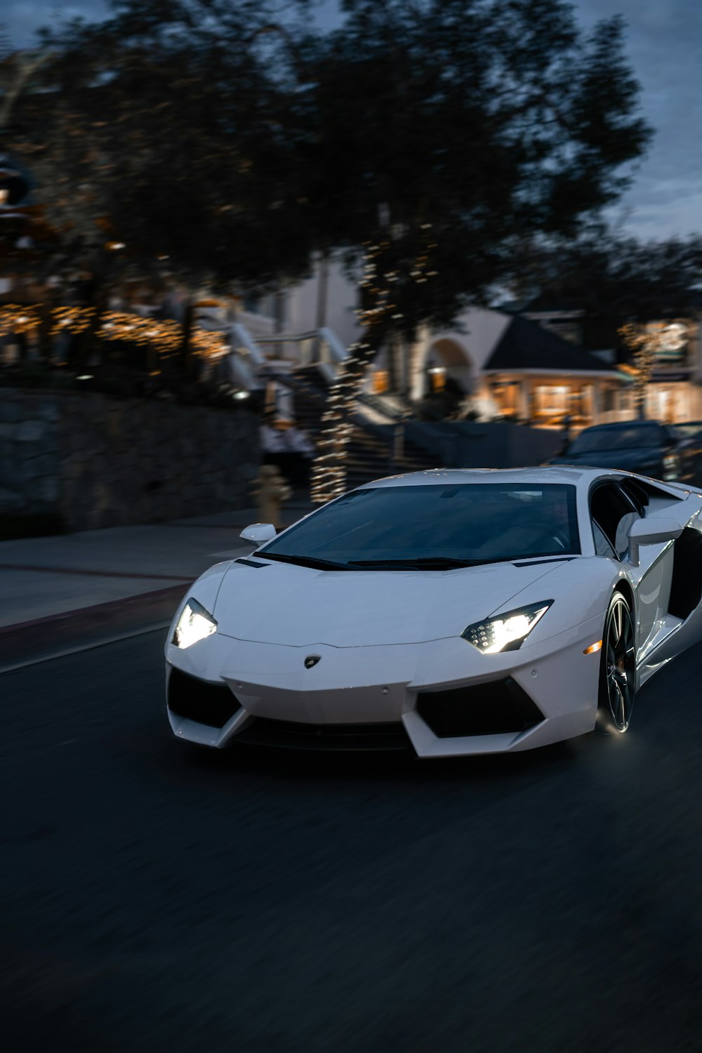 white lamborghini aventador on road during daytime