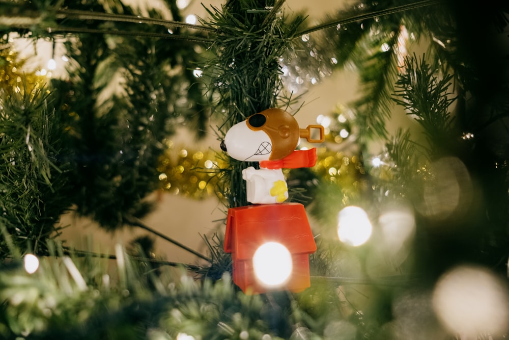 brown bear plush toy hanging on green christmas tree