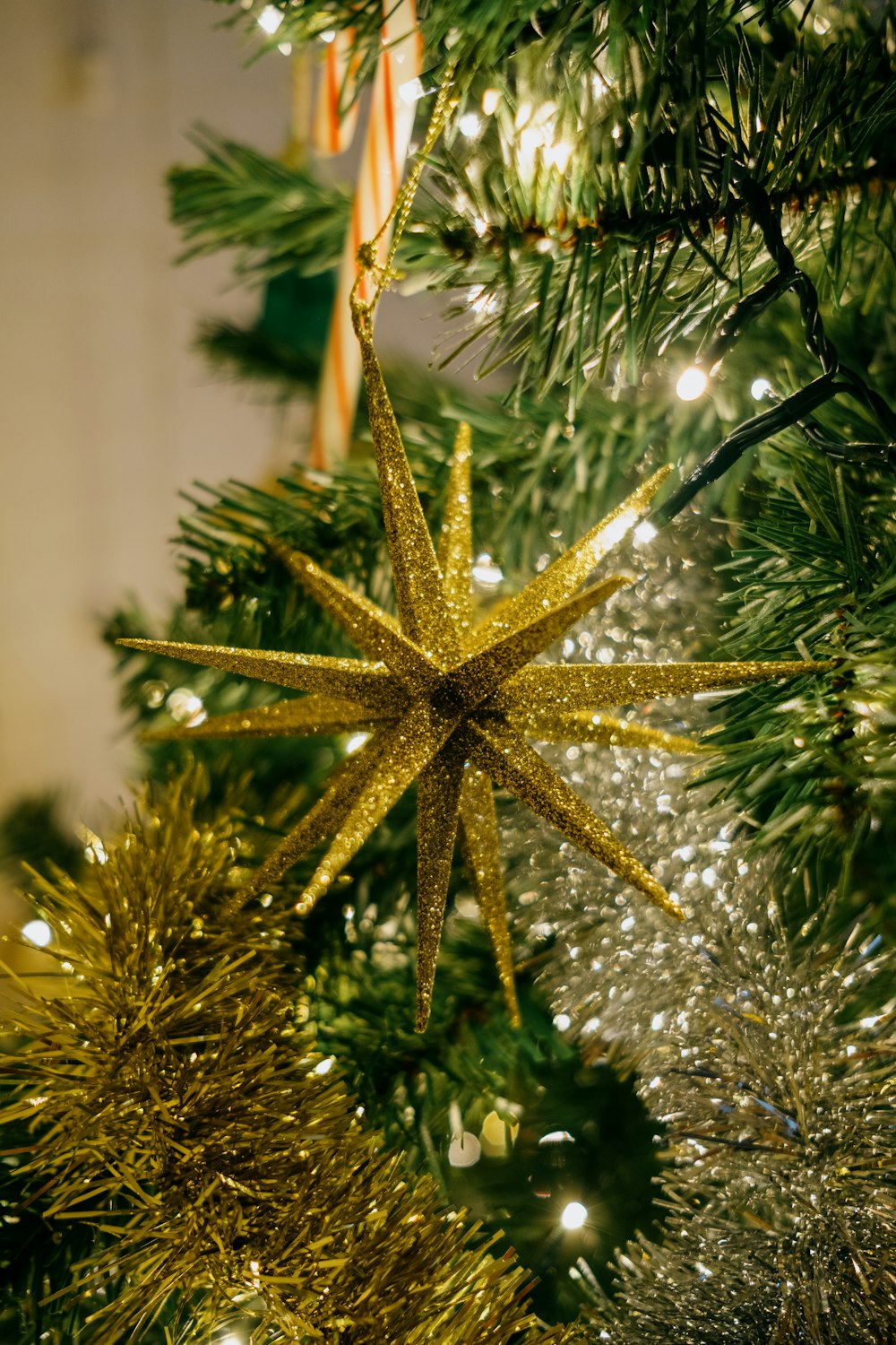brown star ornament on green christmas tree