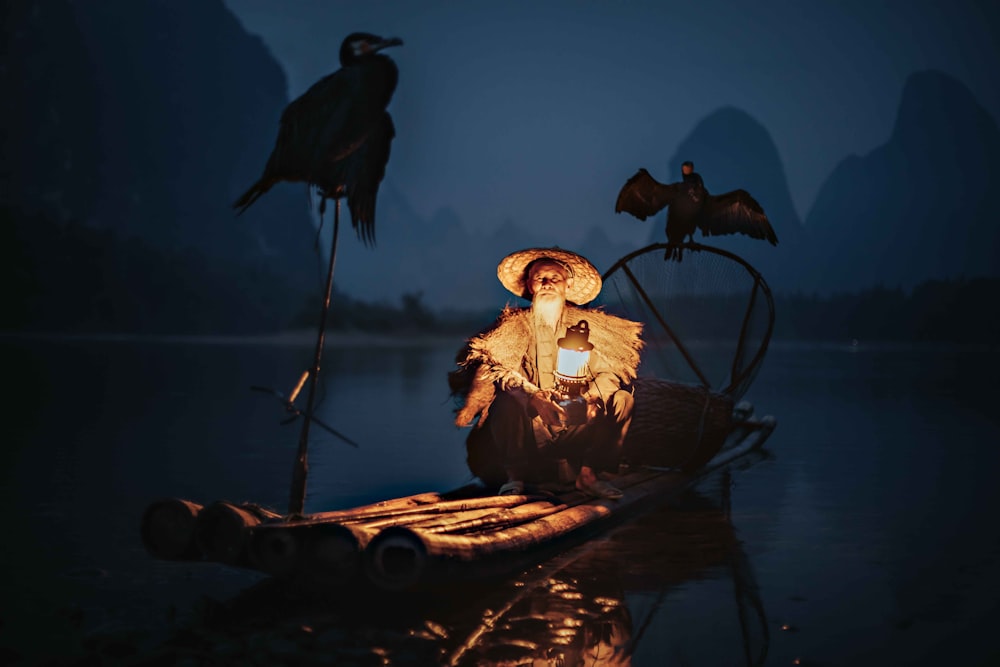 black bird on brown wooden boat on water during daytime