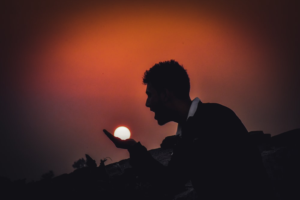 silhouette of man in black suit jacket