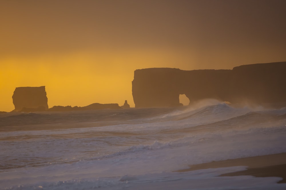 rock formation on white snow covered field during daytime