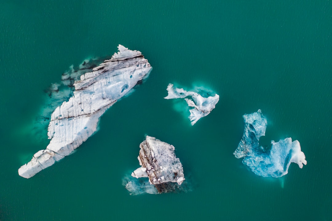 brown and gray rock formation on body of water