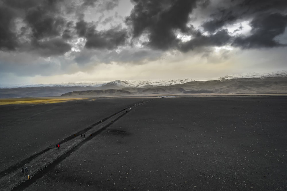 gray concrete road under gray clouds