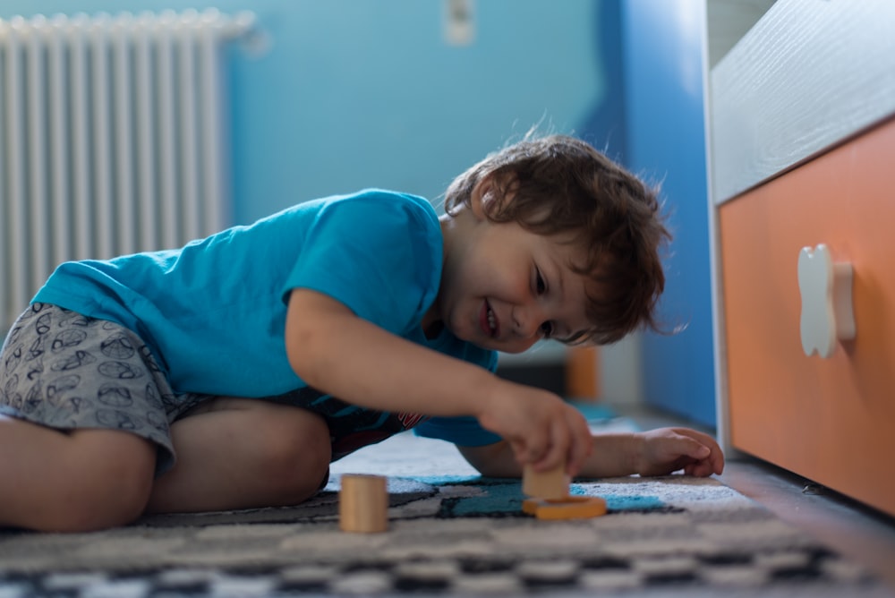 girl in blue t-shirt playing with brown wooden board game