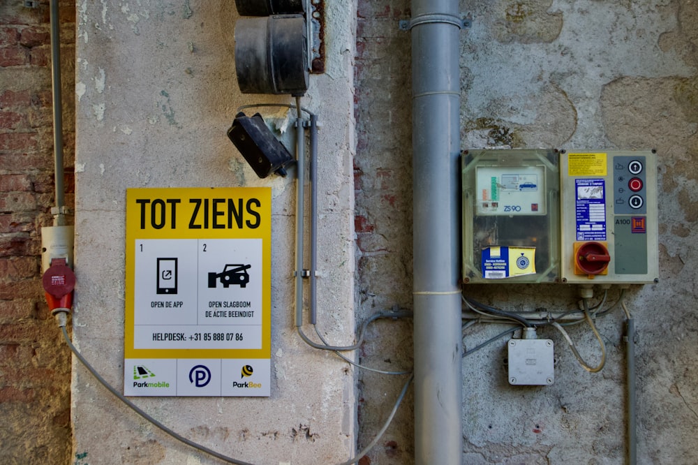 a sign on the side of a building that says tot ziens