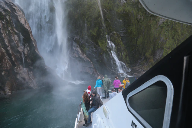 A serene group of travelers meditating near a lush waterfall in the Huasteca region.