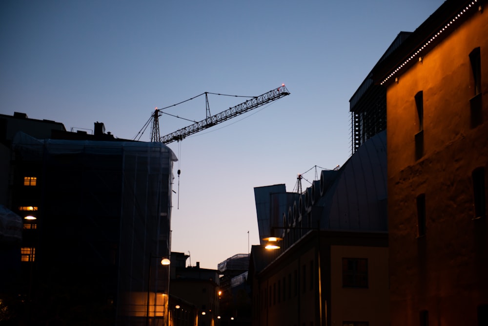 gray crane near building during night time