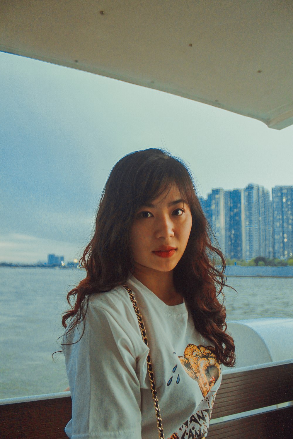 woman in white shirt sitting on white boat during daytime