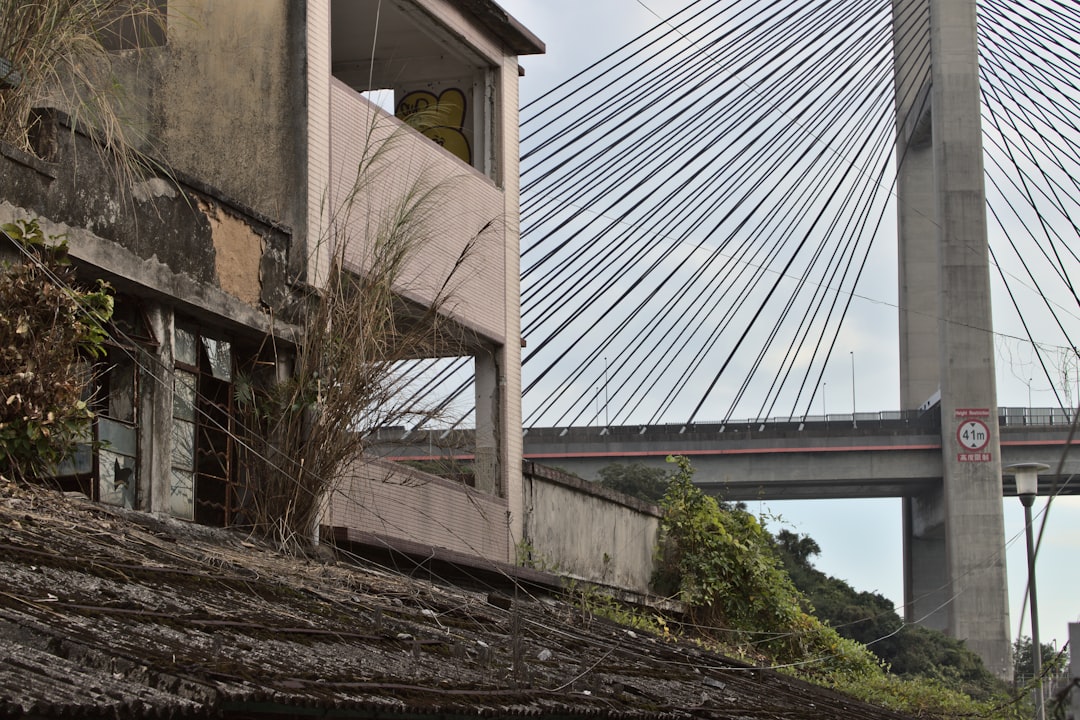 brown concrete building near bridge during daytime