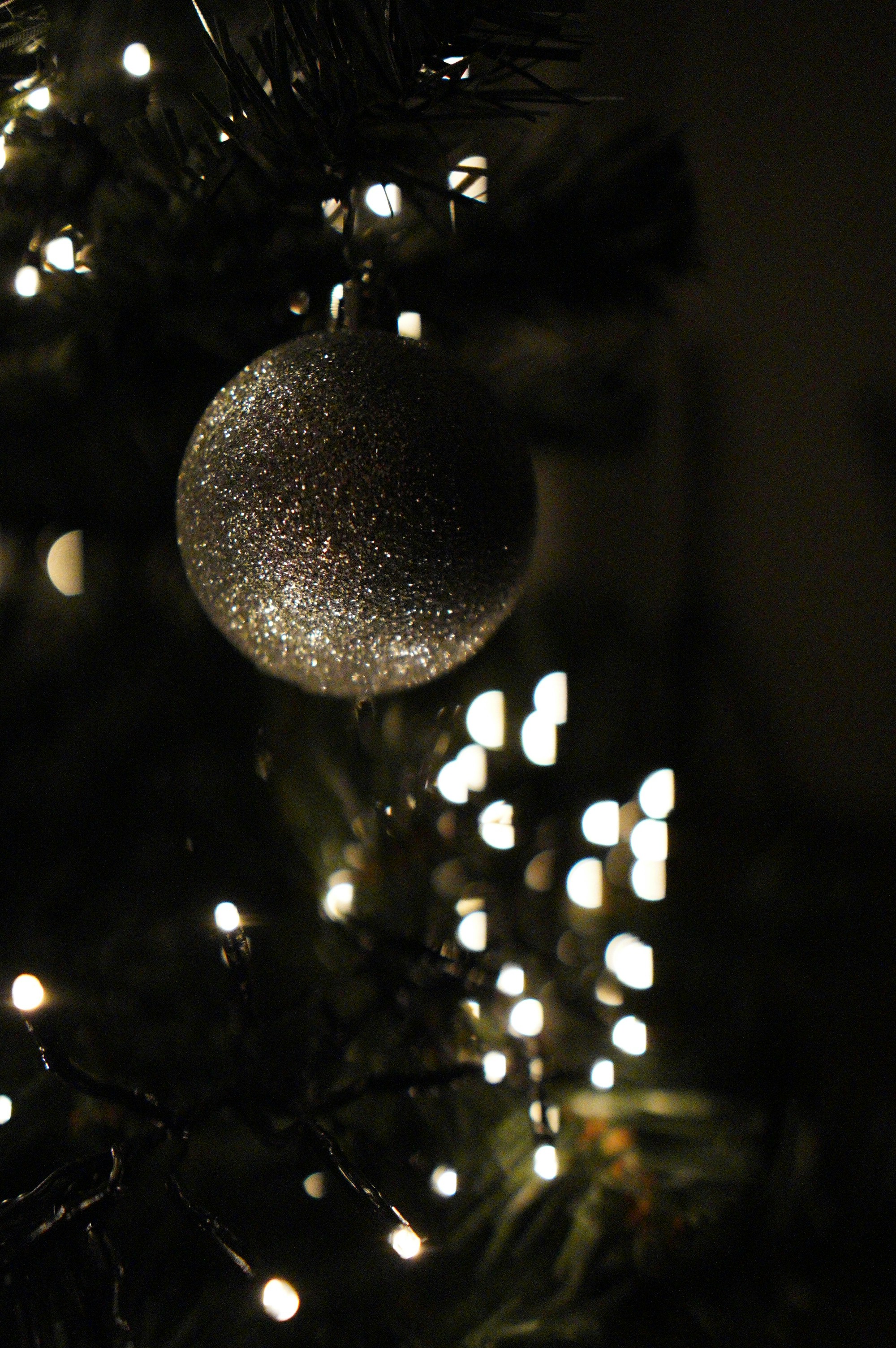silver round ornament on christmas tree