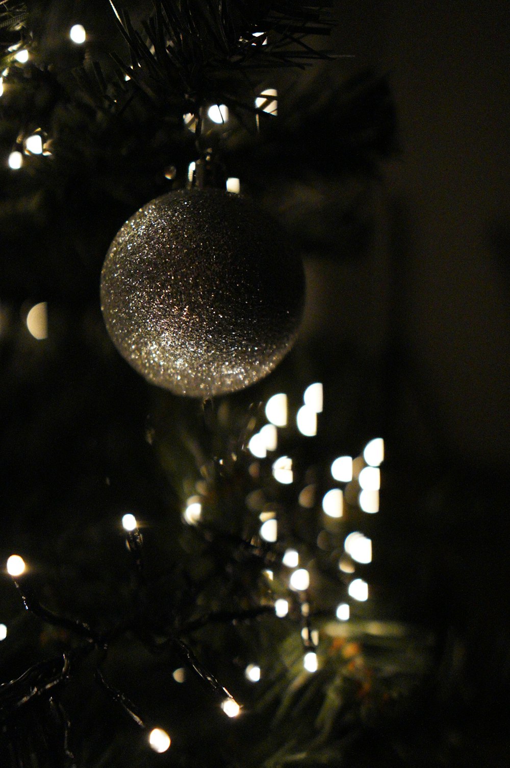 silver round ornament on christmas tree
