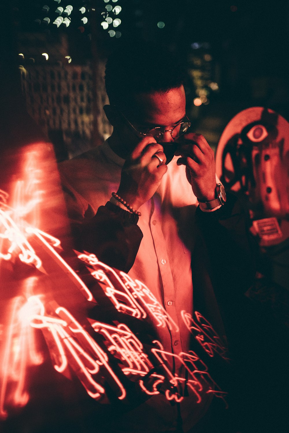 a man standing in front of a red light