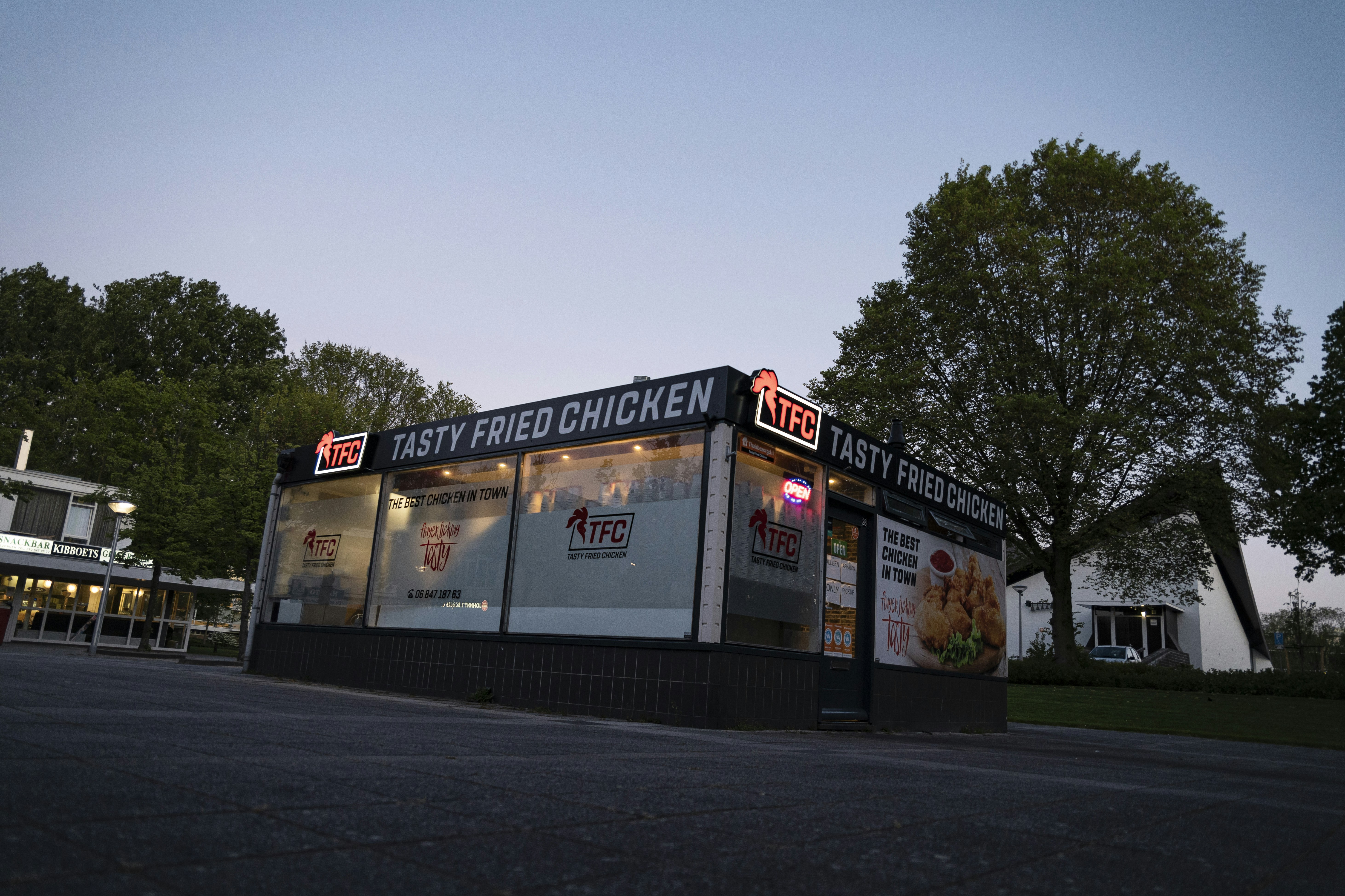 Dutch tasty fried chicken fast food shop during sunset