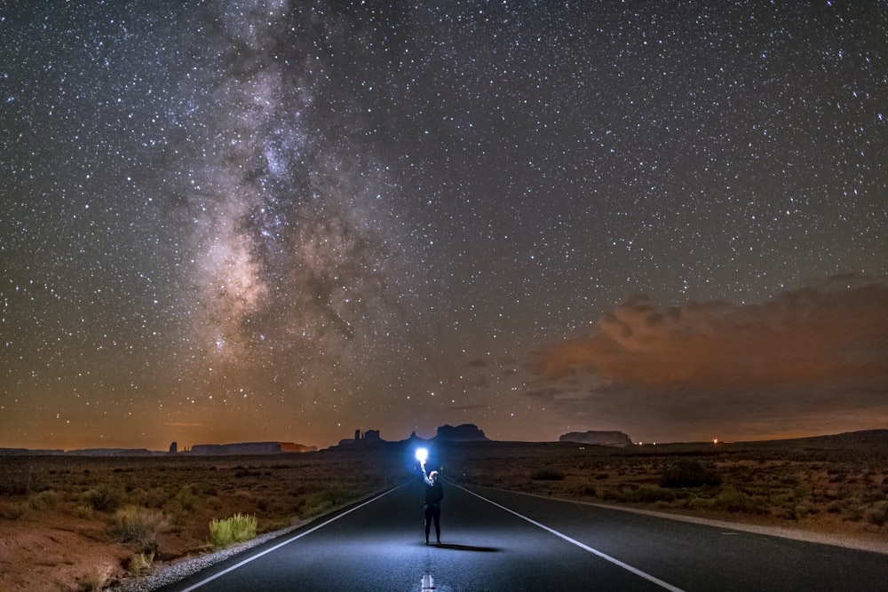 black car on road under starry night