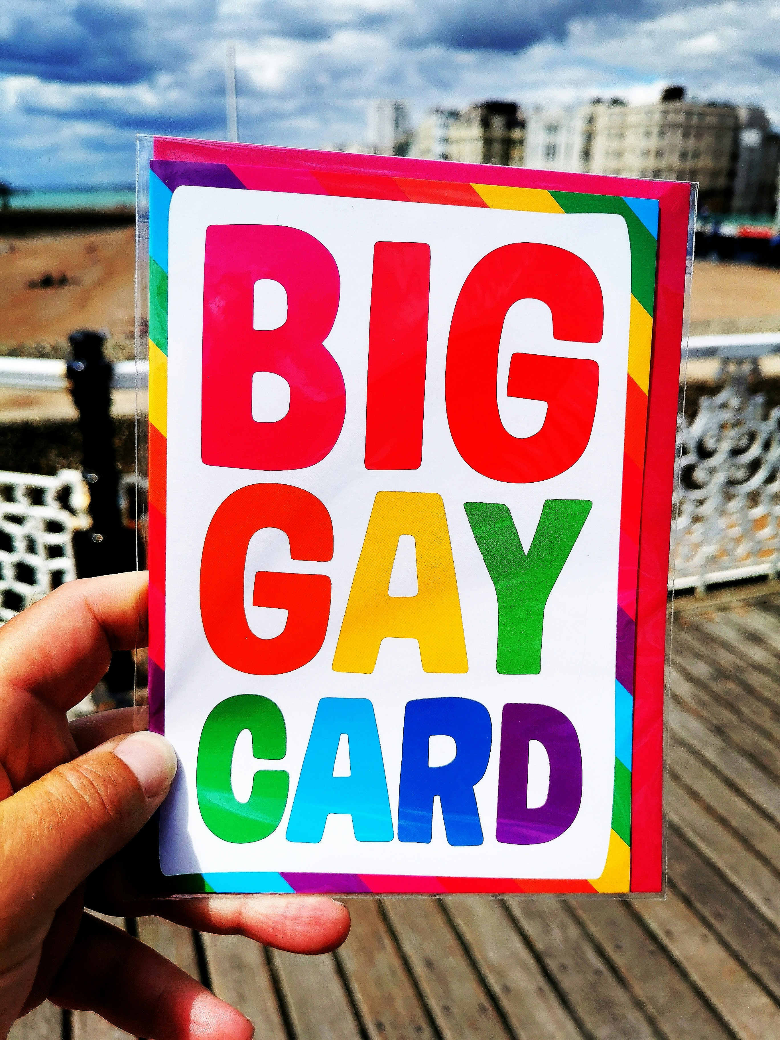 person holding white red and green happy birthday card