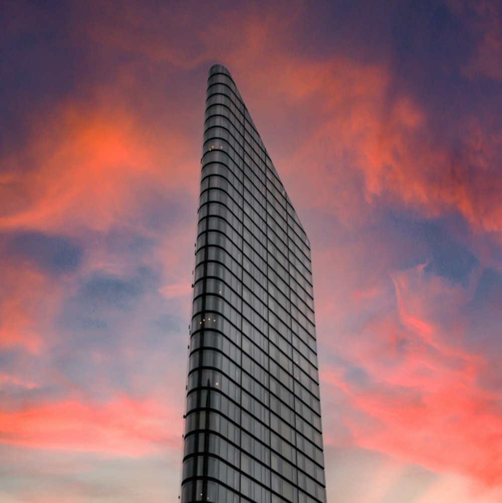 white and black high rise building under orange and blue sky