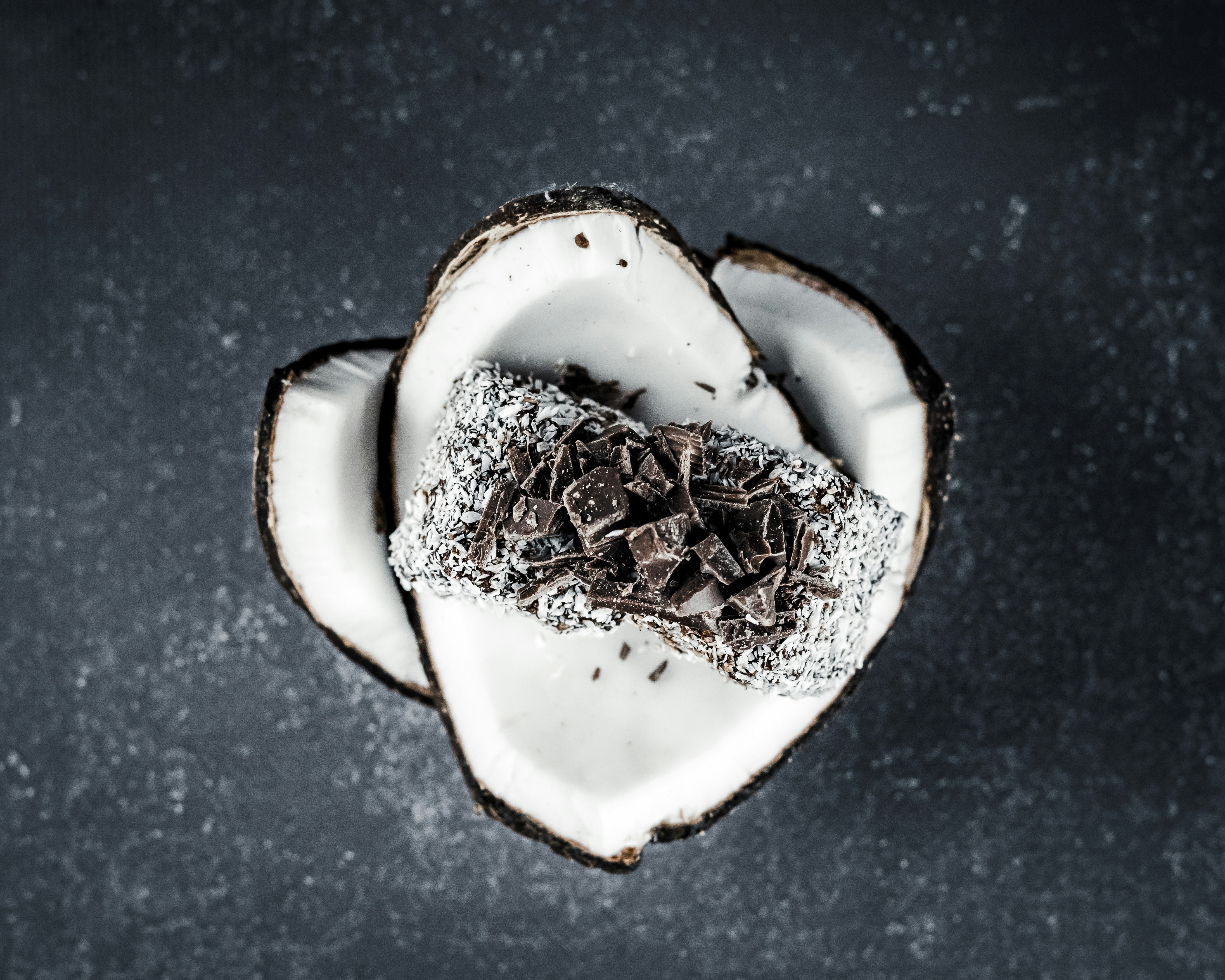 Flat lay food photography of chocolate glazed cake with coconut sprinkle