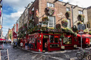 The Temple Bar pub with hanging flower baskets on a cobblestone street in Dublin