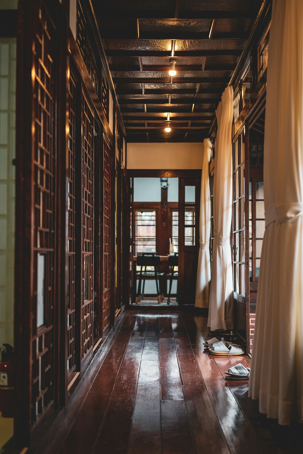 brown wooden room with white curtains