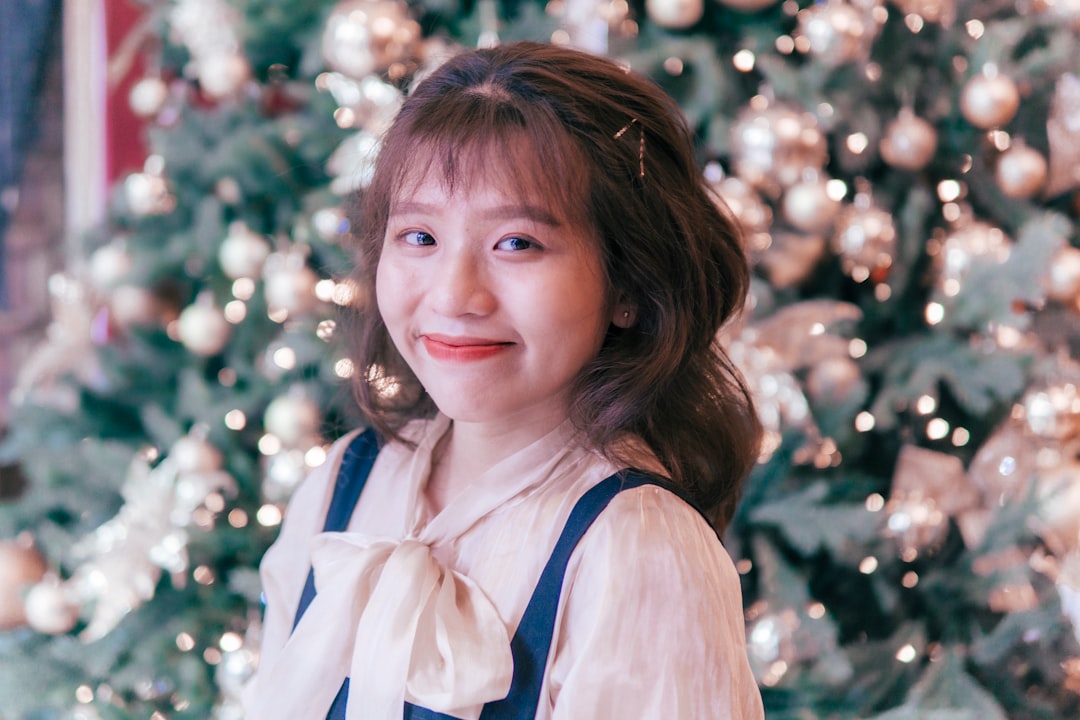 girl in white sleeveless shirt smiling