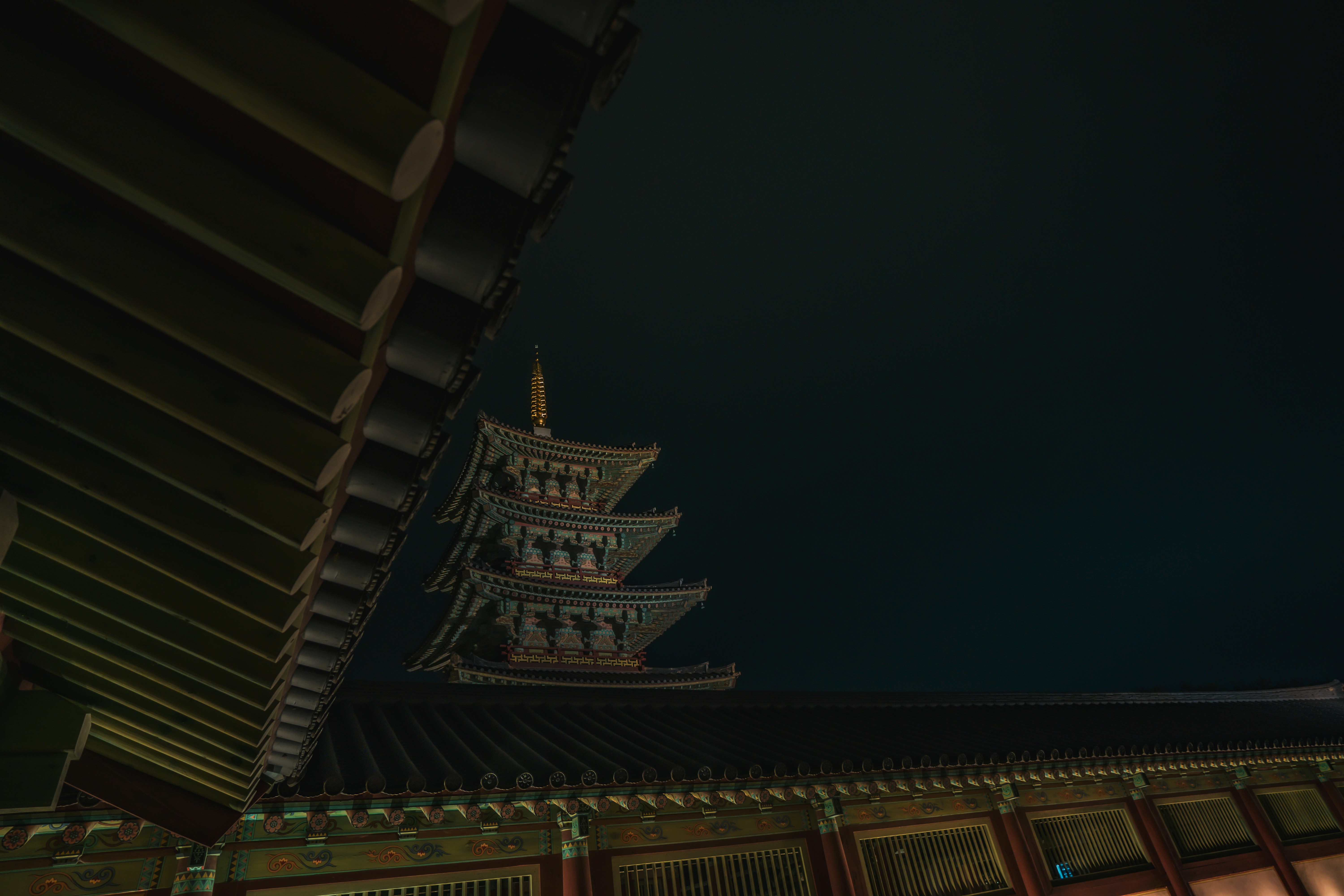 brown wooden roof with lights during night time