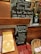 A display at Starbucks promoting a Diwali blend coffee. The setup includes a chalkboard with handwritten details, including flavor notes and pricing for the new blend. A basket with bottled juices and boxes of chocolates are also featured. A QR code stand is present for ordering options.