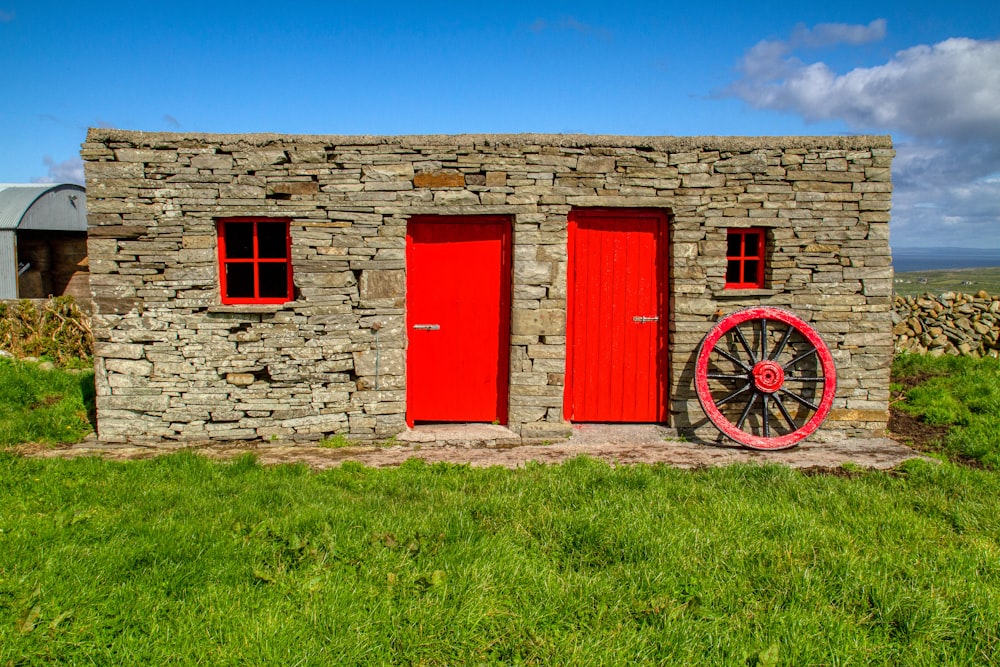 red wooden door on brown brick wall