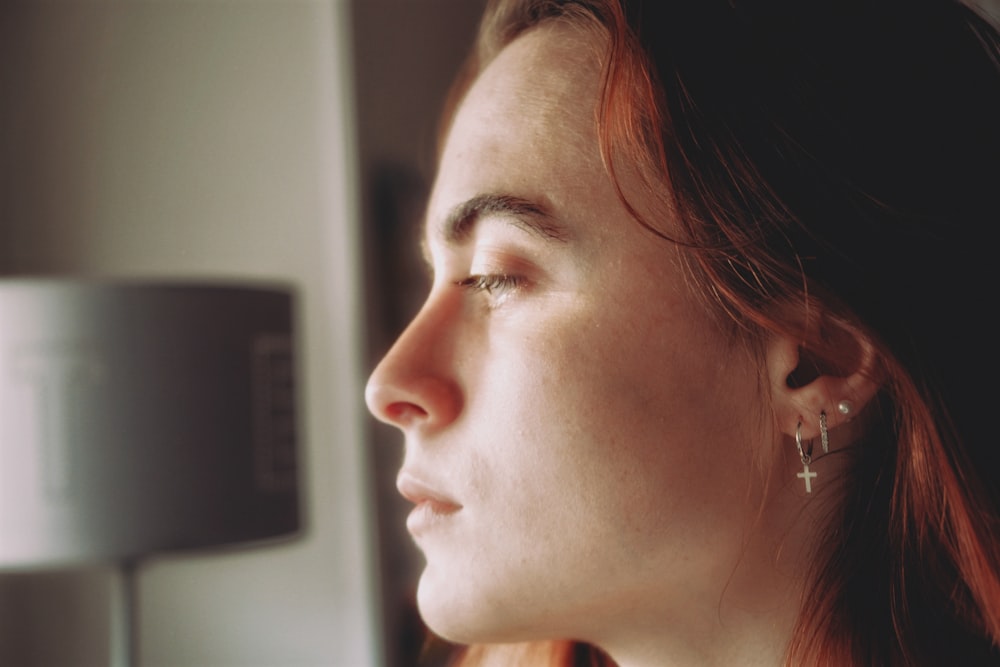 woman with brown hair wearing silver earring