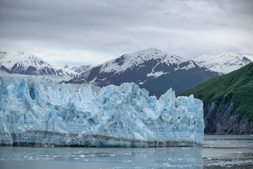 brown and white mountain near body of water during daytime