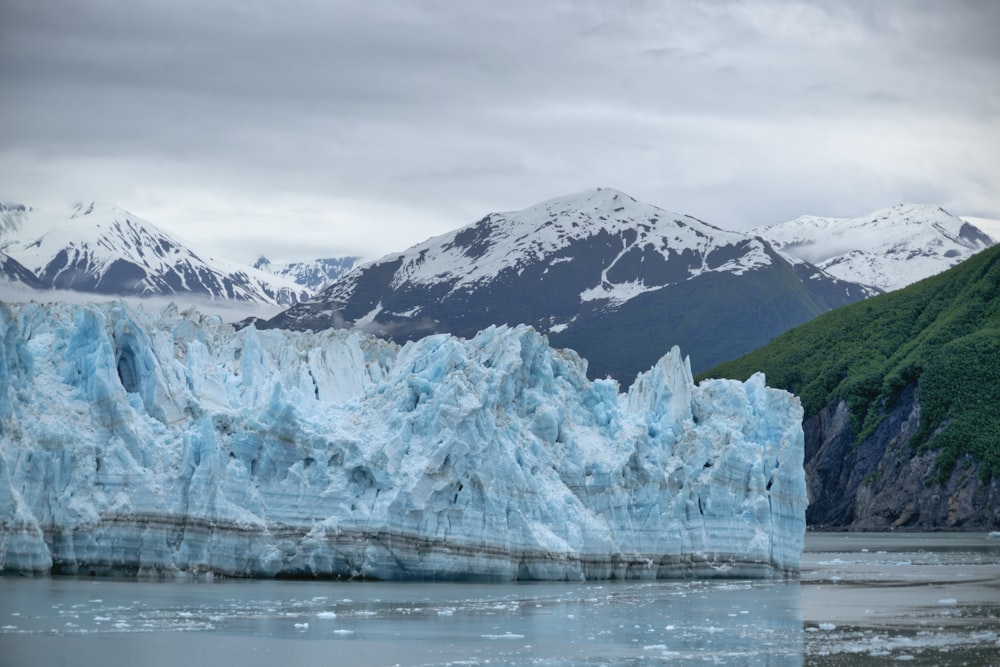 brown and white mountain near body of water during daytime