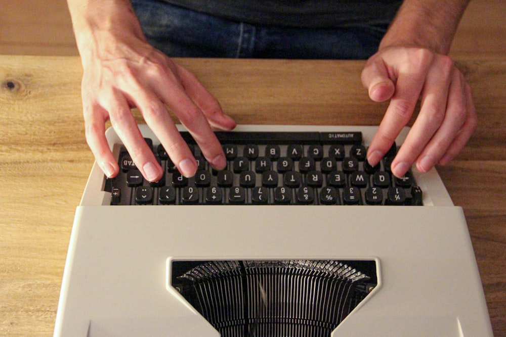 person holding black and silver computer keyboard