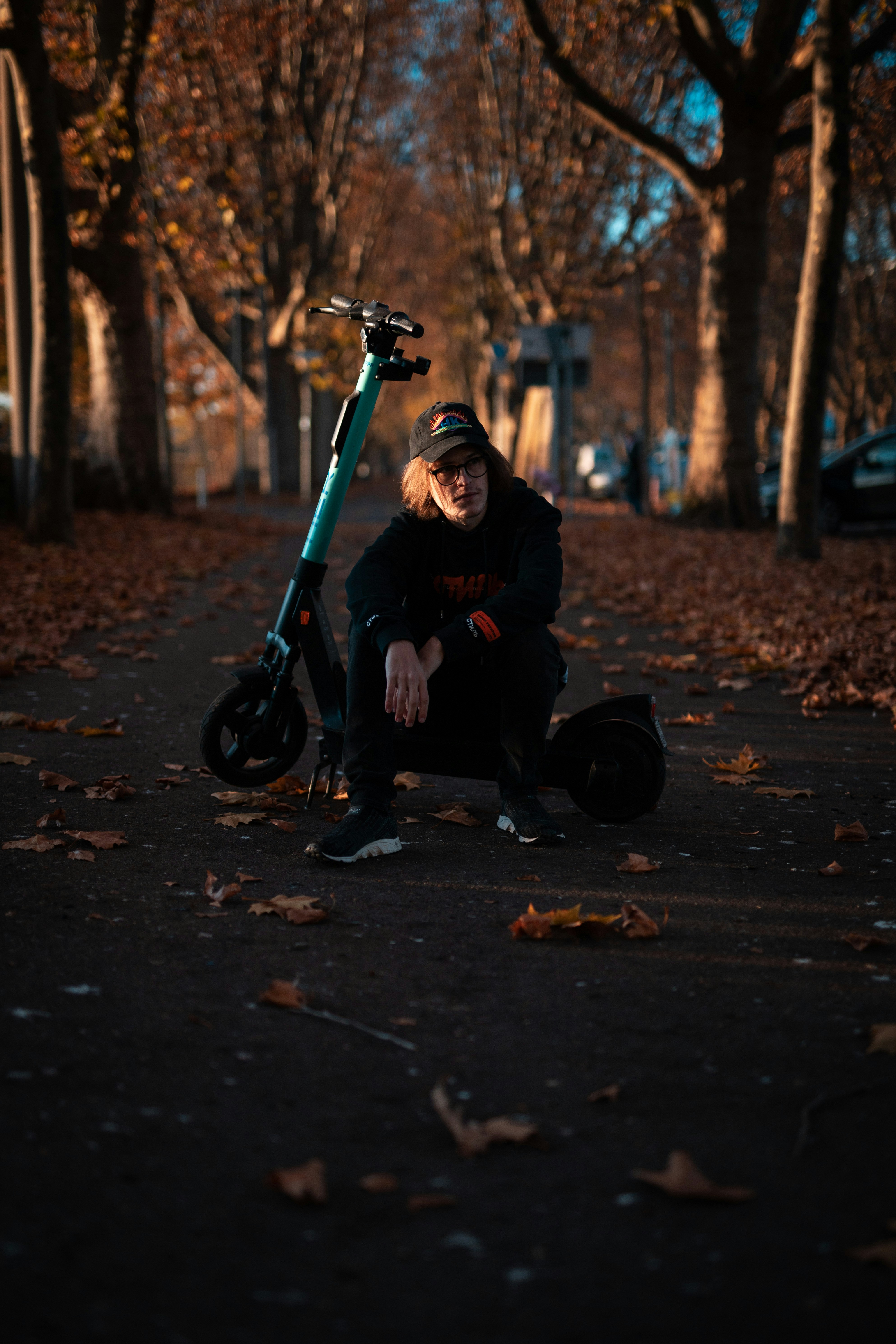 man in black jacket and black pants sitting on black motorcycle during daytime