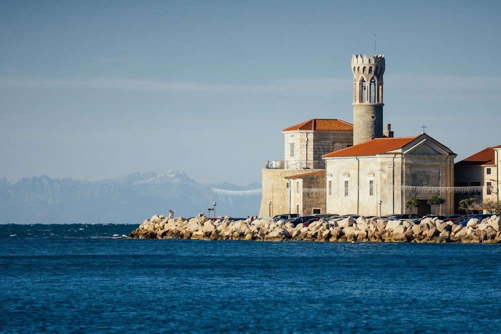 white and brown concrete building near body of water during daytime