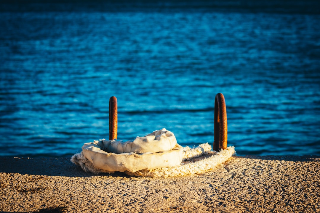 white ice cream on brown sand near body of water during daytime