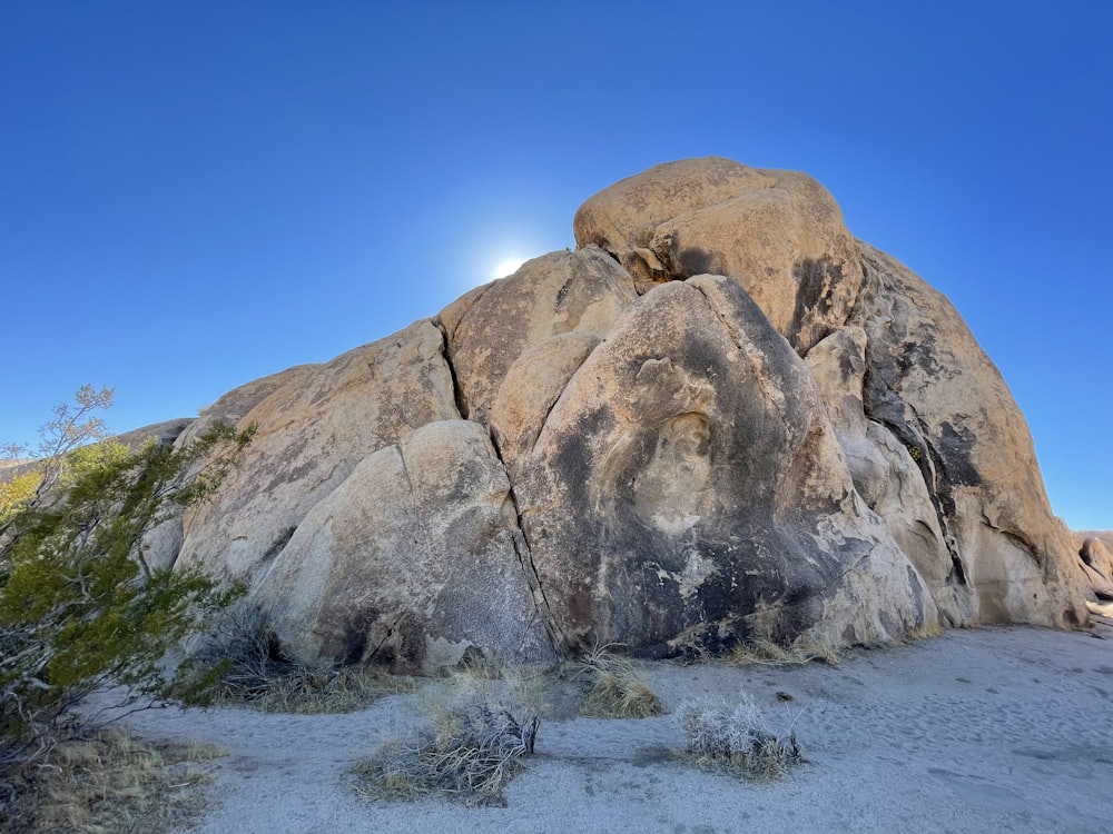 brown rock formation on snow covered ground under blue sky during daytime