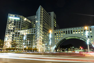 A night shot of a modern office lit with green neon lights.