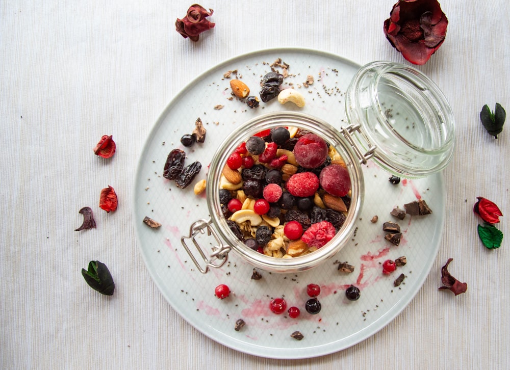 red and green fruit on white ceramic round plate