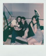 Friends casually lounging on floor loungers, sharing laughs in a relaxed setting.