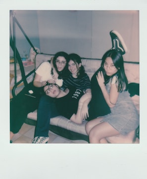 Friends casually lounging on floor loungers, sharing laughs in a relaxed setting.