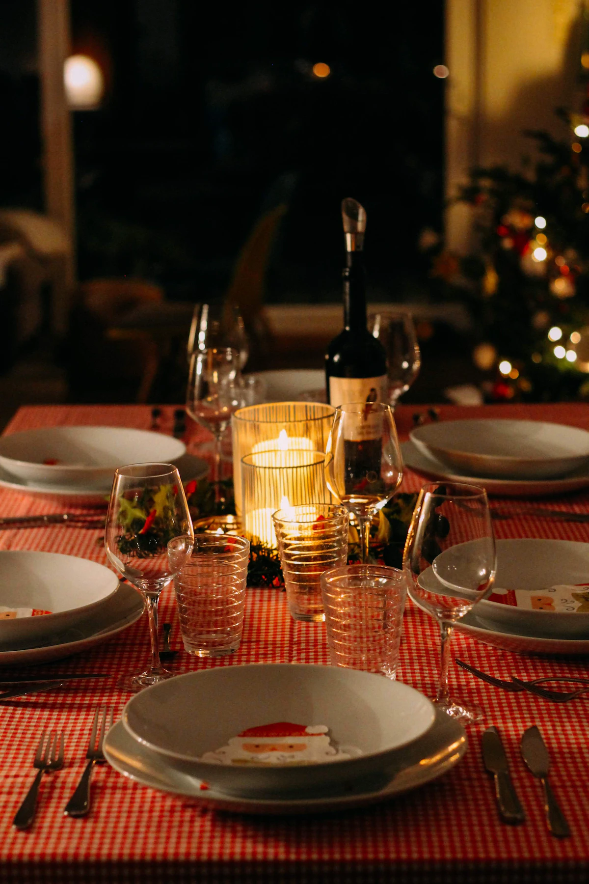 Candle flickering on a long evening reception table.