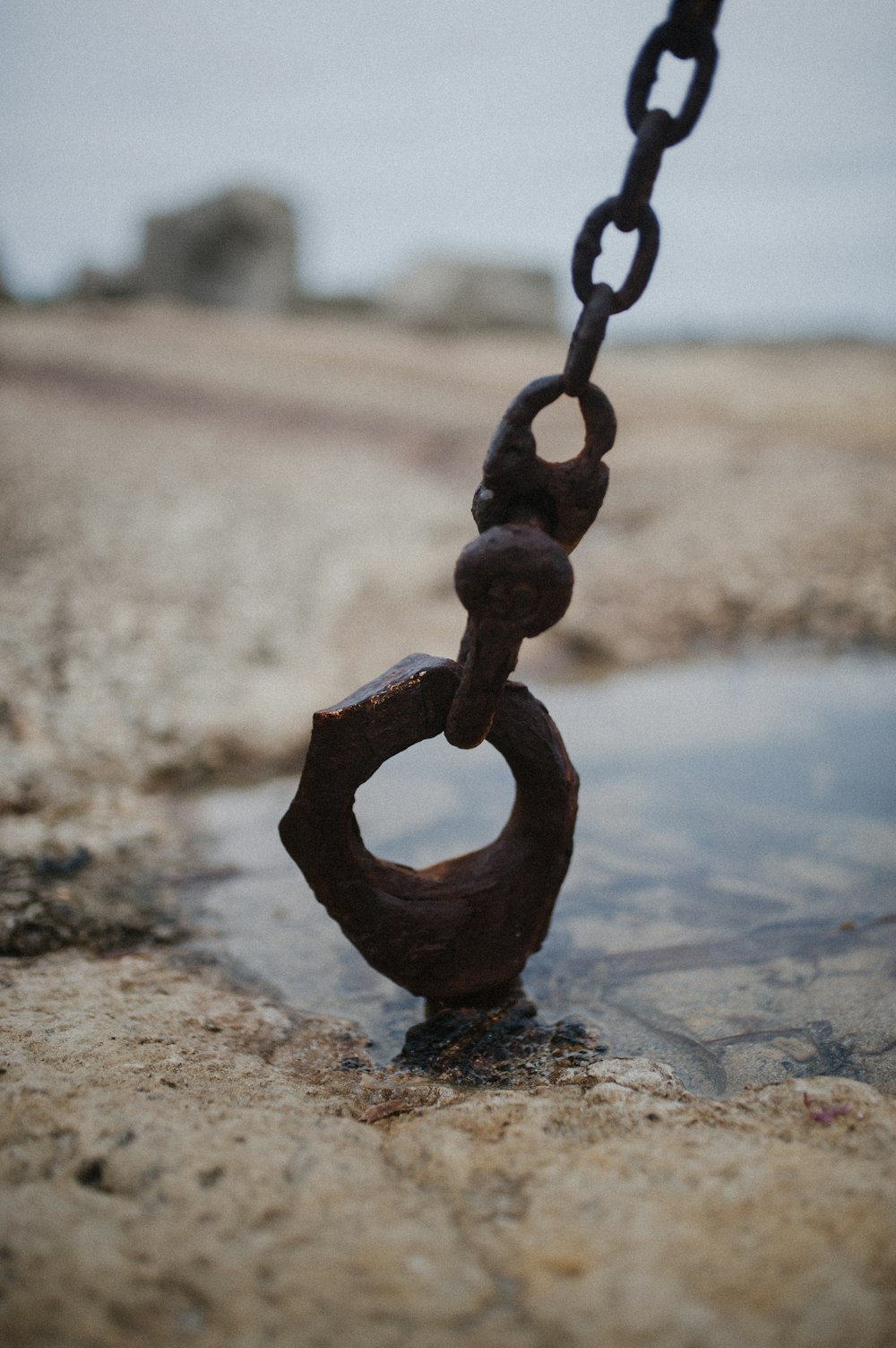 black metal chain on grey concrete floor