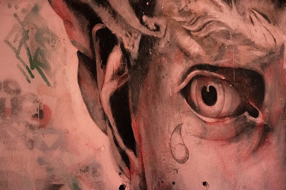 mans face with red eyes painting