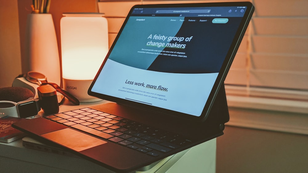 black tablet computer on white and brown table