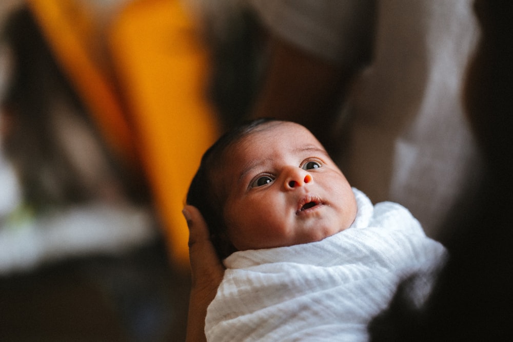 baby in white and yellow stripe shirt