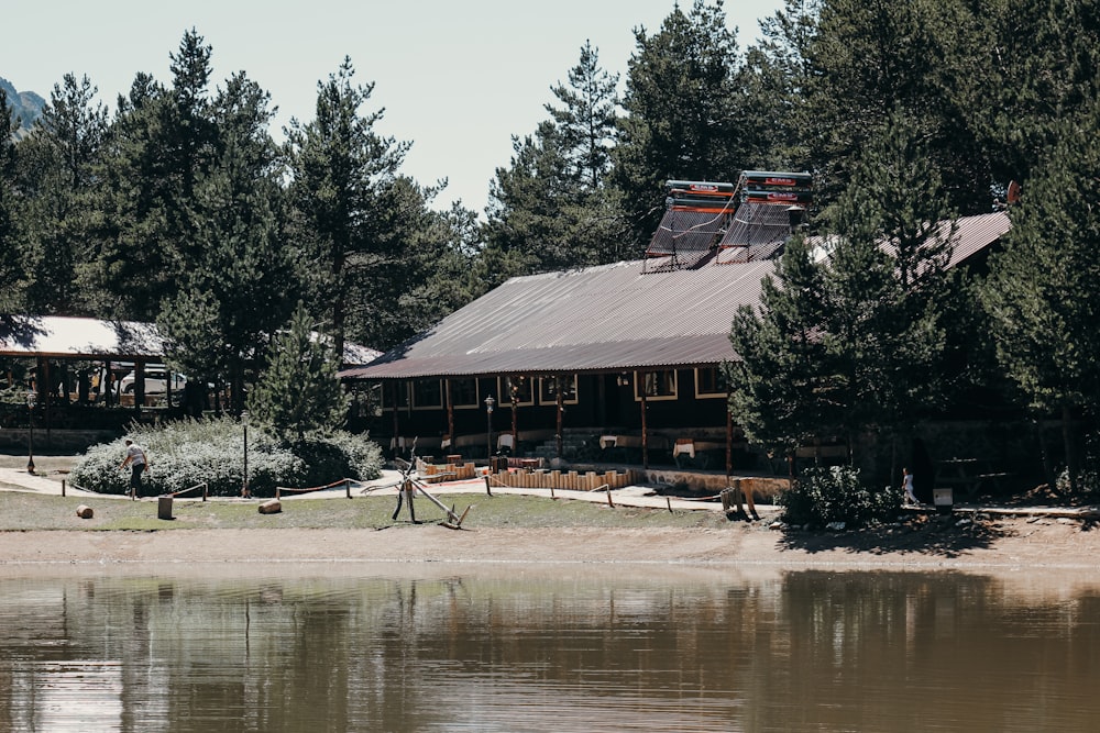 brown wooden house near lake during daytime