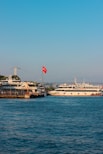 white and brown ship on sea under blue sky during daytime
