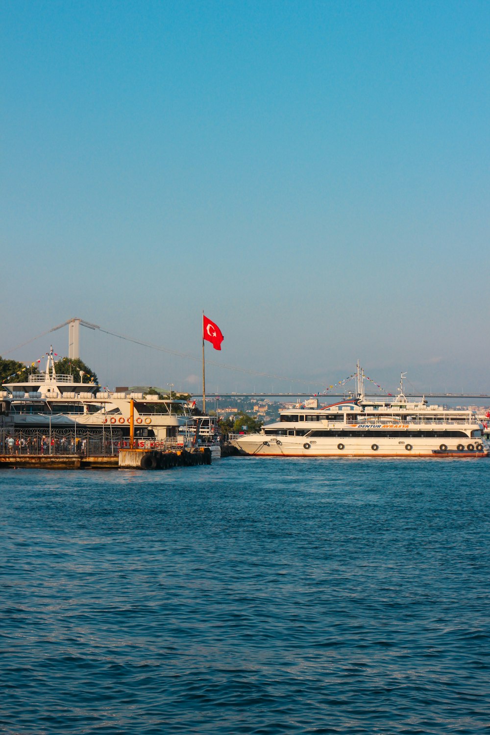 white and brown ship on sea under blue sky during daytime